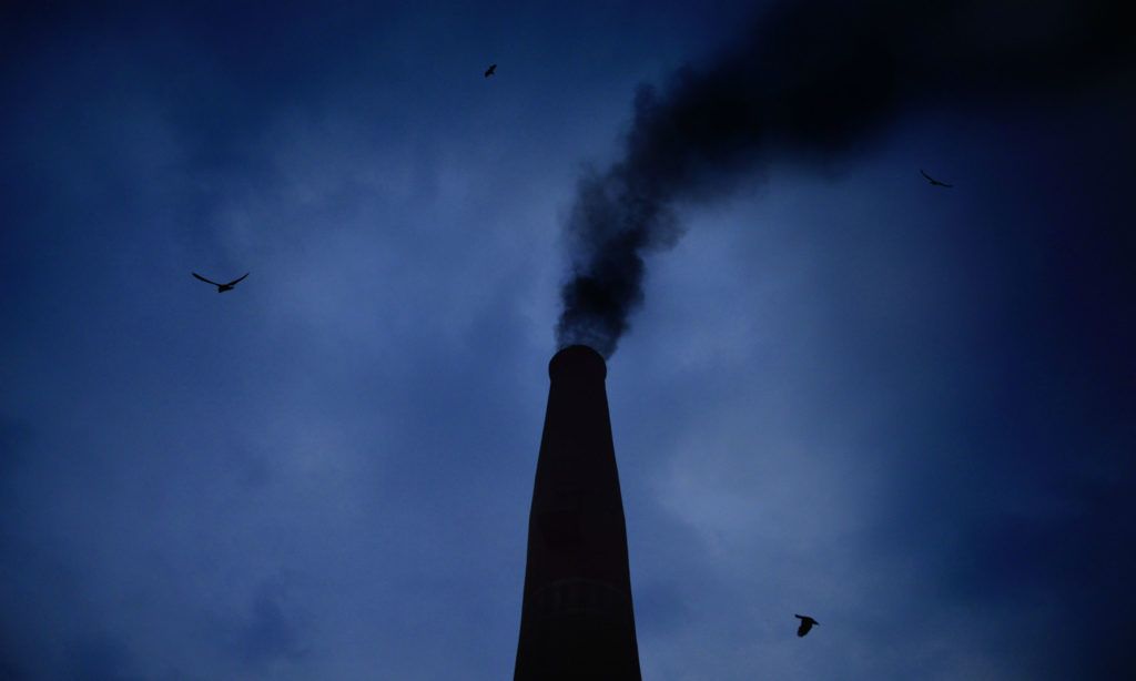 A chimney with smoke coming out the top