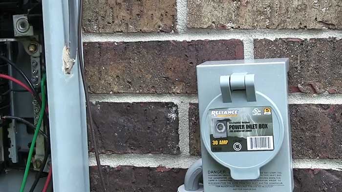 power inlet box on a brick wall